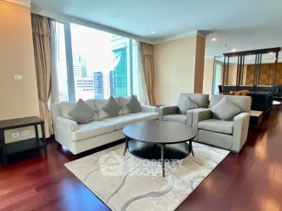 Luxurious living room with city view, featuring elegant furniture and hardwood floors.