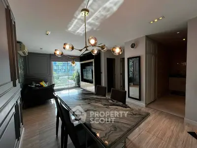 Luxurious modern living room with elegant dining area and stylish lighting in high-rise apartment.