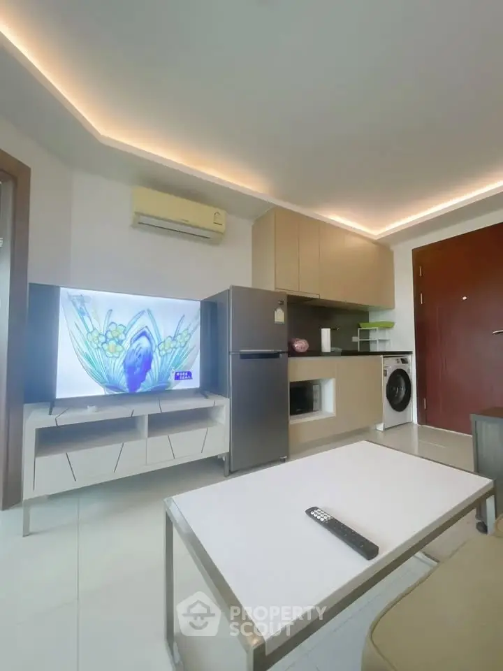 Modern living room with sleek furniture and built-in appliances