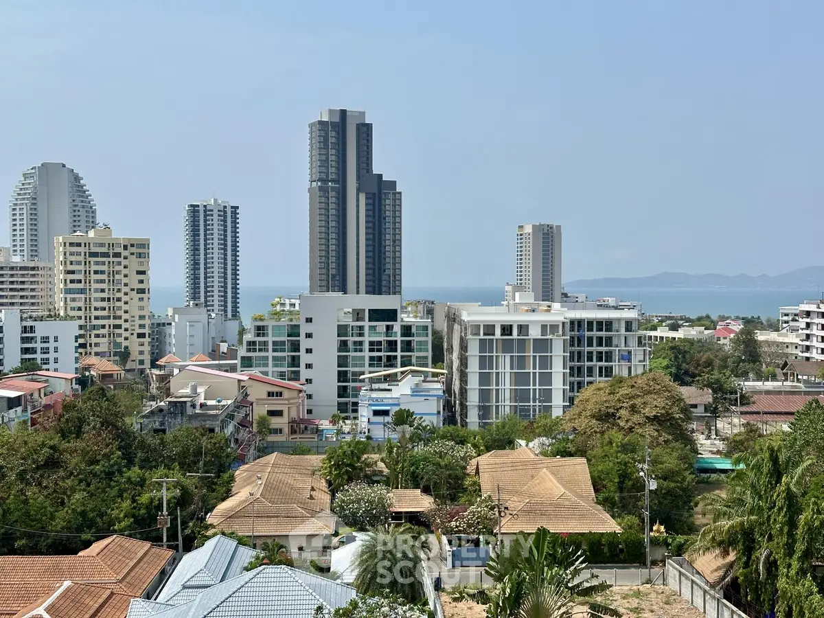 Stunning cityscape view with modern high-rise buildings and ocean backdrop, perfect for urban living enthusiasts.