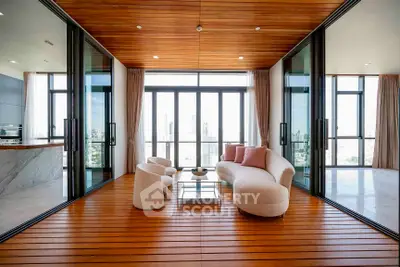 Luxurious modern living room with panoramic city views and elegant wooden flooring.