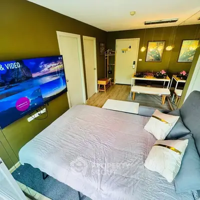 Cozy living room with modern decor and wall-mounted TV, ideal for relaxation.