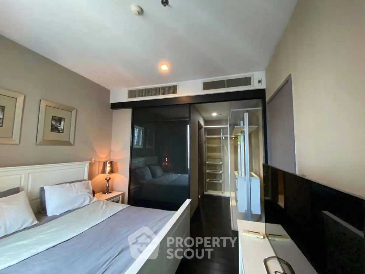 Modern bedroom with sleek design and ample natural light, featuring a stylish bed and contemporary decor.