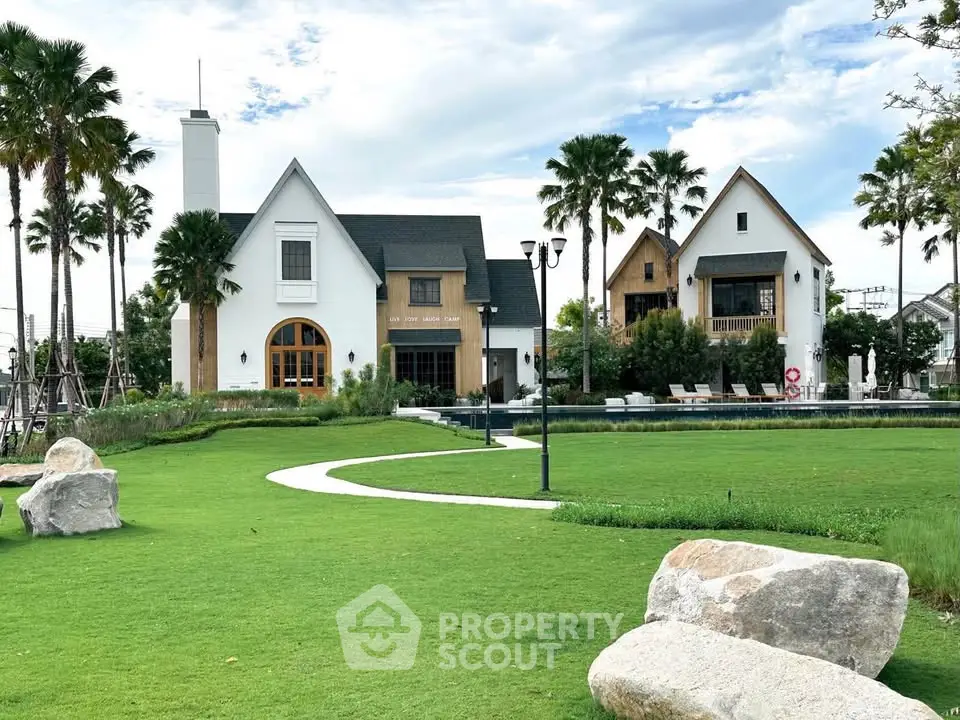 Stunning modern estate with lush green lawn and elegant architecture, perfect for luxury living.