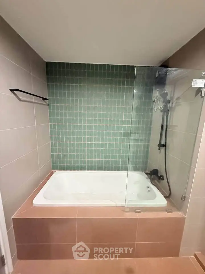 Modern bathroom with stylish bathtub and glass shower enclosure