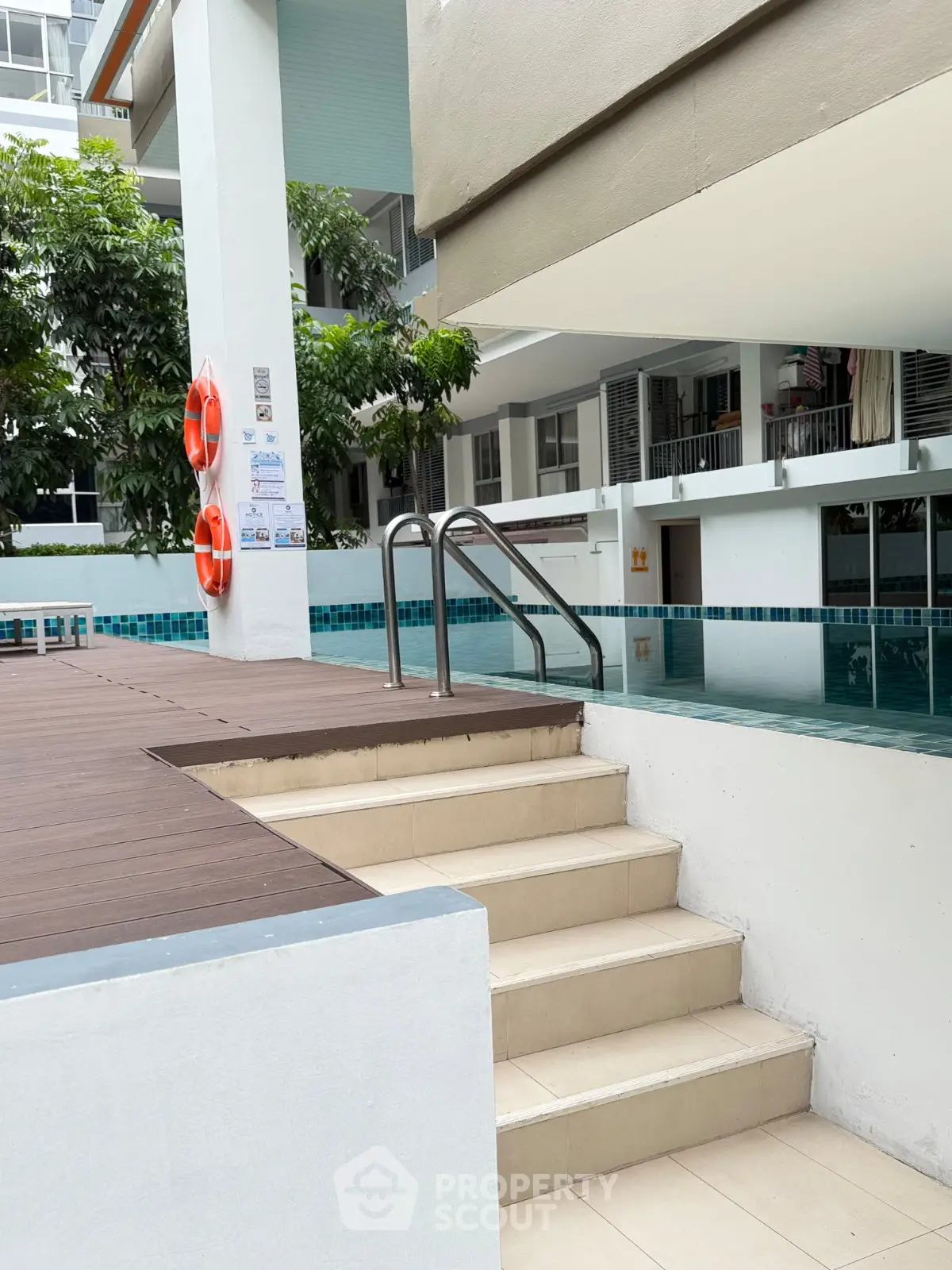 Modern condominium pool area with safety features and stylish design.