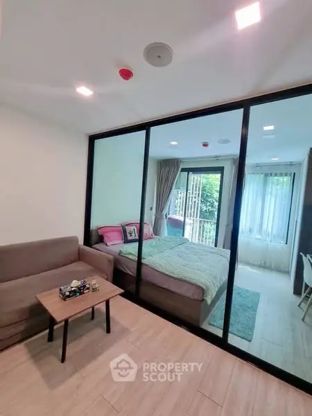 Modern studio apartment with glass partition and cozy furnishings