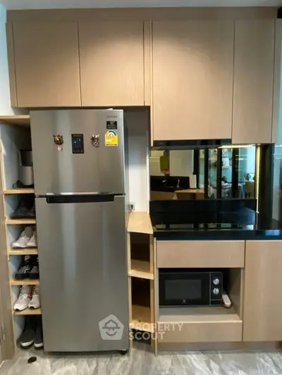 Modern kitchen with stainless steel fridge and built-in microwave