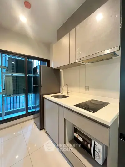 Modern kitchen with sleek cabinetry and built-in appliances in a stylish apartment.