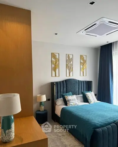 Luxurious bedroom with elegant decor and plush bedding in modern apartment.