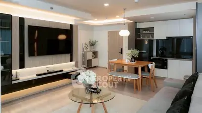 Modern living room with sleek furniture and open kitchen layout