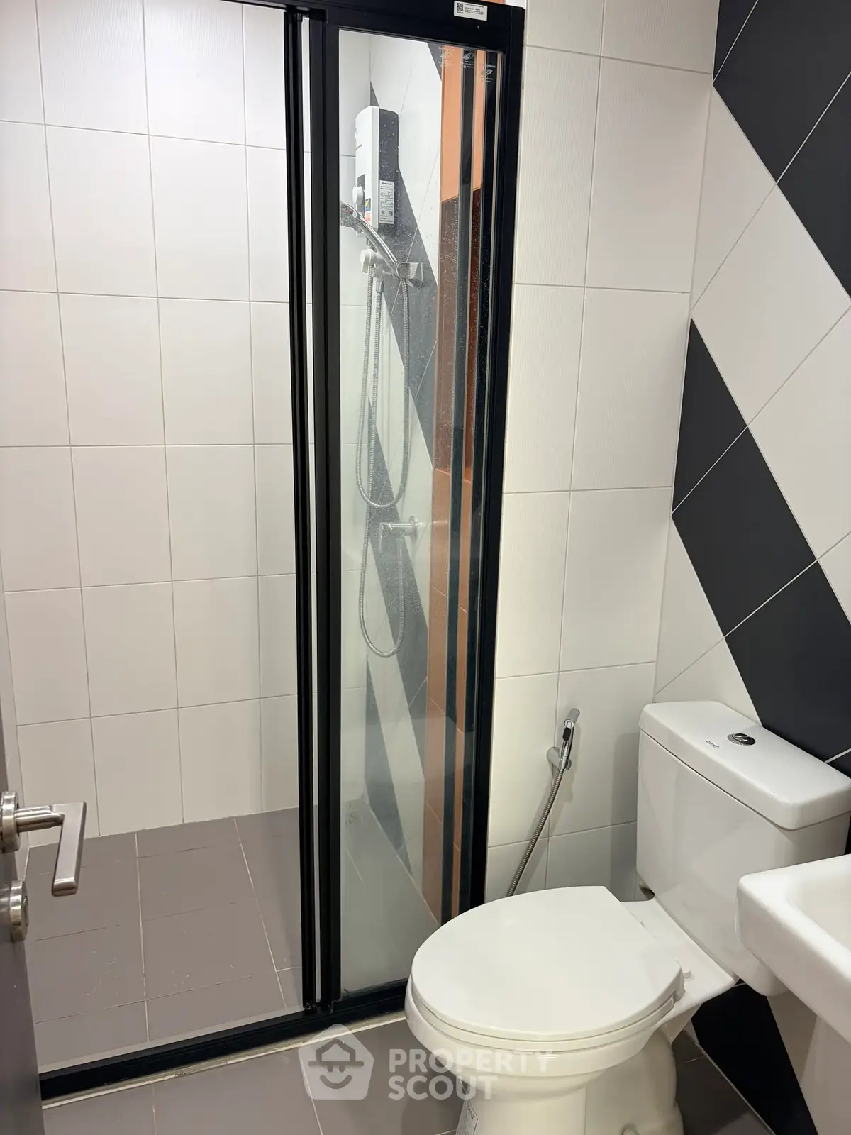 Modern bathroom with sleek shower enclosure and stylish tile design.