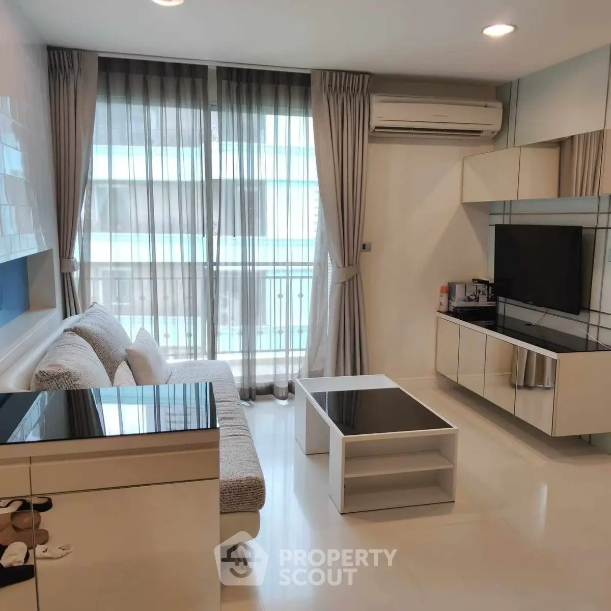 Modern living room with sleek furniture and large windows in a stylish apartment.