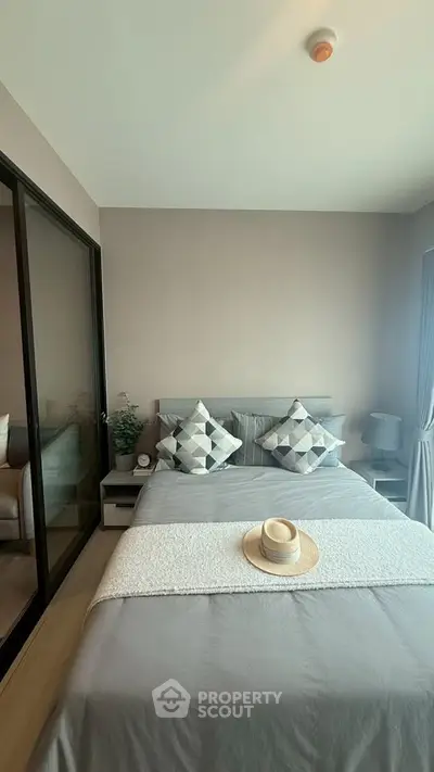 Cozy modern bedroom with stylish decor and ample natural light
