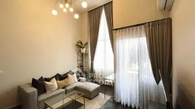 Modern living room with high ceiling and elegant decor