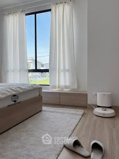 Bright minimalist bedroom with large window and modern decor