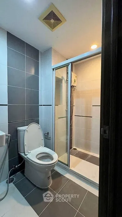 Modern bathroom with sleek tiles and glass shower enclosure