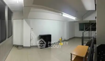 Spacious interior with modern design and ample natural light, featuring sleek flooring and minimalist decor.