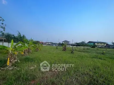 Spacious green land plot with potential for development in a serene neighborhood.