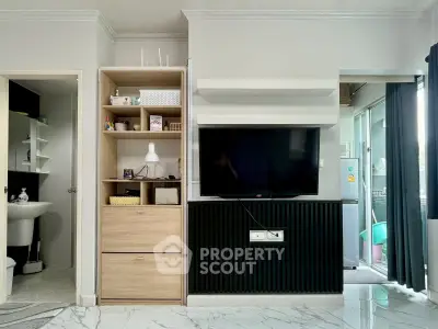 Modern living room with sleek TV setup and stylish shelving, featuring elegant marble flooring and contemporary decor.
