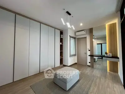 Spacious modern bedroom with sleek design and ample storage space