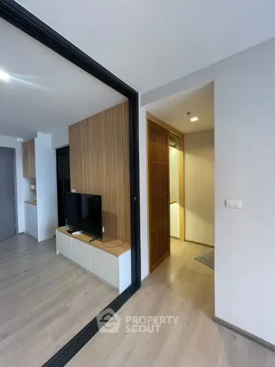 Modern living room with sleek wooden paneling and TV unit