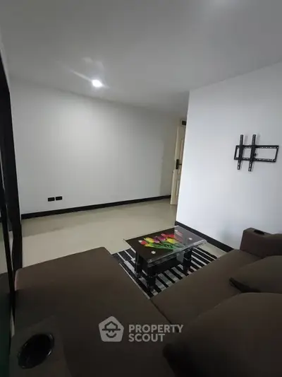 Modern living room with sleek design and comfortable seating in a contemporary apartment.