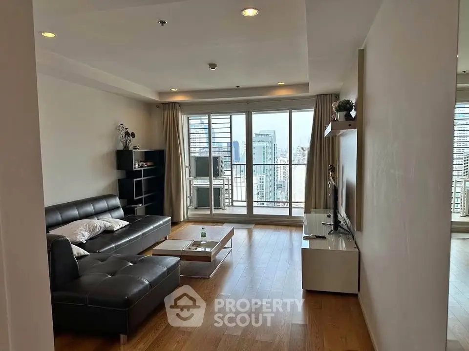 Spacious modern living room with city view and sleek furnishings