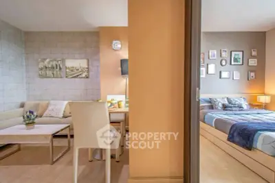 Modern open-plan living room and bedroom with stylish decor and cozy ambiance.