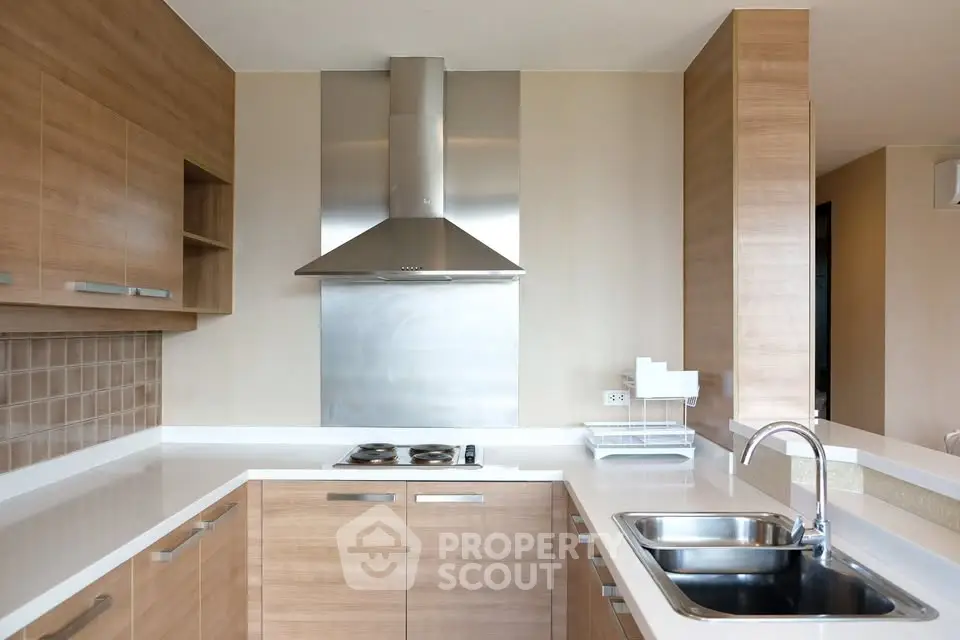 Modern kitchen with sleek wooden cabinets and stainless steel appliances