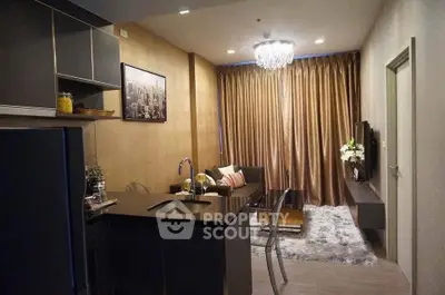 Modern living room with open kitchen, elegant decor, and cozy seating area.