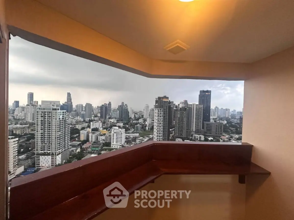 Stunning cityscape view from a high-rise balcony, showcasing urban skyline and modern architecture.