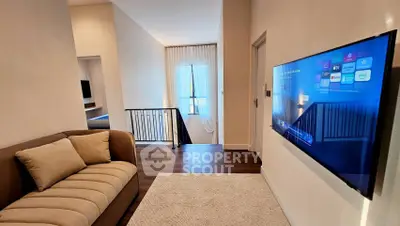 Modern living area with wall-mounted TV and cozy sofa in stylish home