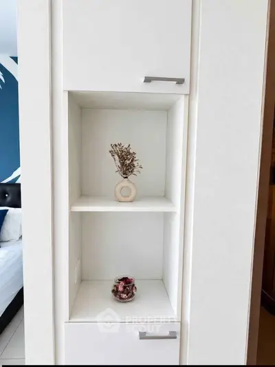 Modern bedroom with stylish white shelving and decorative accents