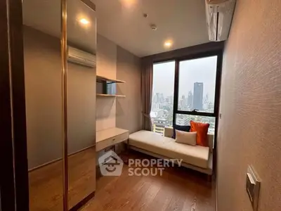 Modern bedroom with city view, featuring sleek furniture and large window.