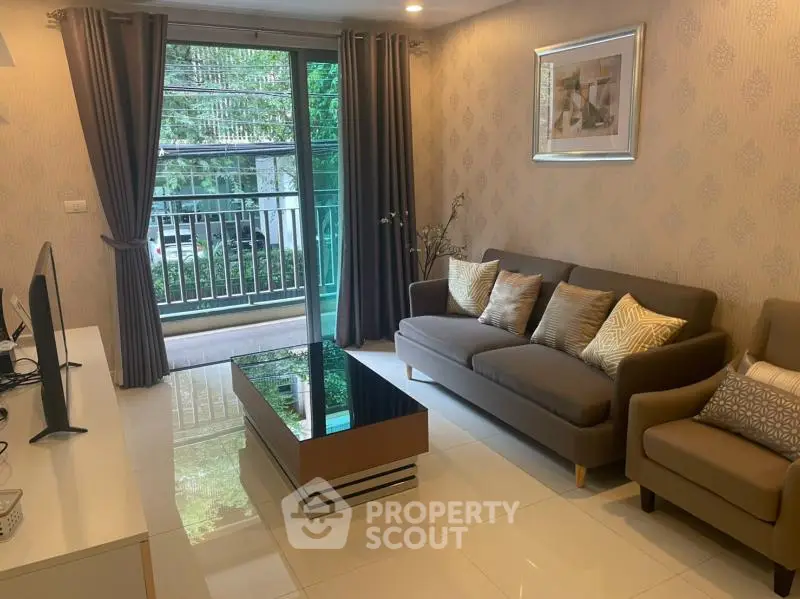 Modern living room with stylish decor and balcony view in a cozy apartment.