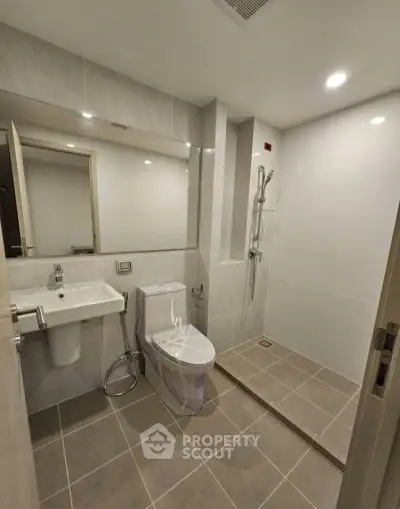 Modern bathroom with sleek fixtures and spacious shower area