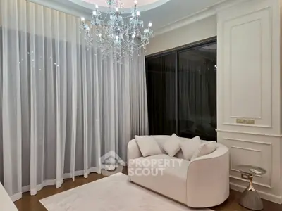 Elegant living room with chandelier and plush white sofa