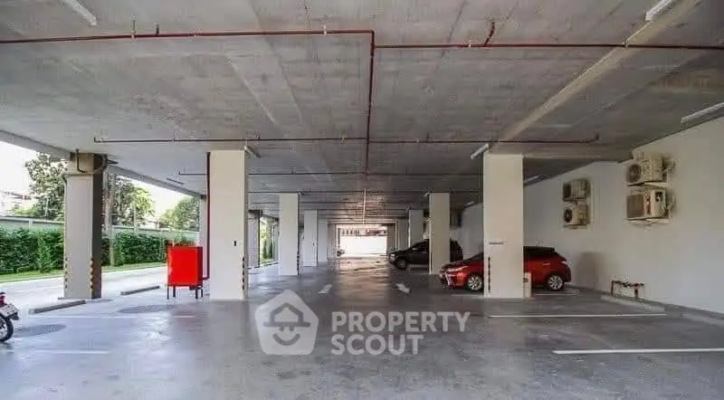 Spacious parking area with ample space and modern design in a residential complex.