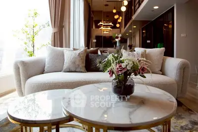 Luxurious modern living room with elegant sofa and marble coffee tables in high-rise apartment.