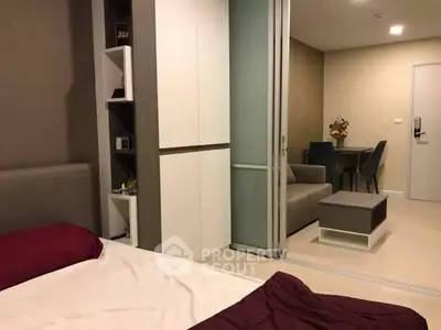 Modern bedroom with sliding doors leading to a cozy living area
