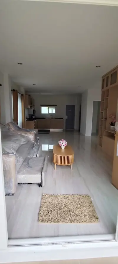 Spacious living room with modern furniture and open kitchen layout