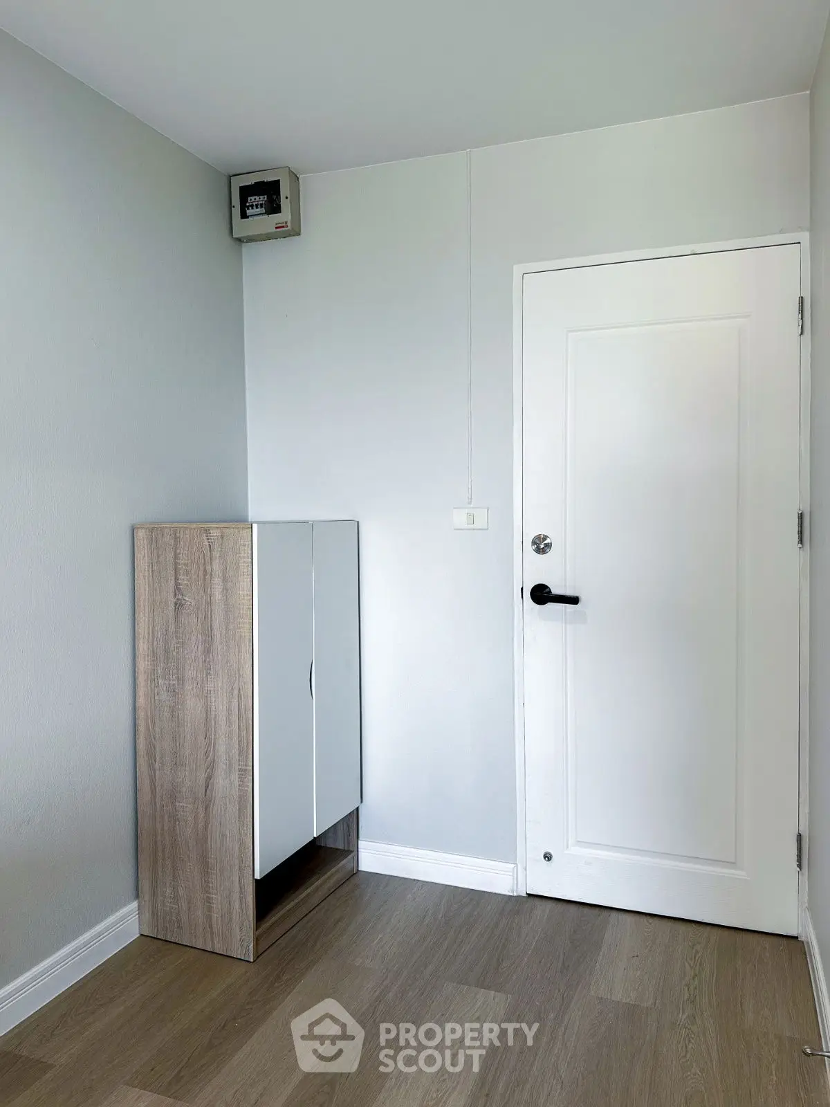 Minimalist interior with wooden cabinet and white door in modern home