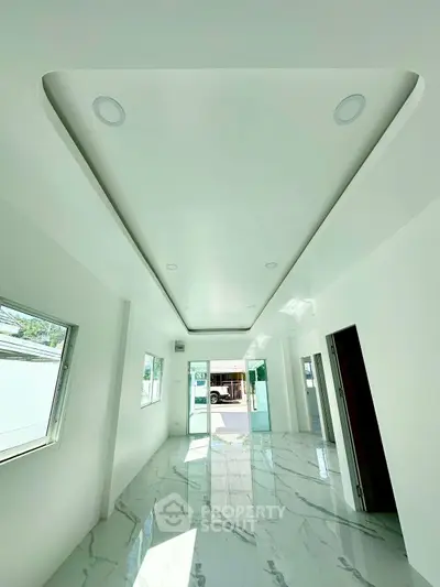 Spacious modern interior with sleek marble flooring and recessed lighting