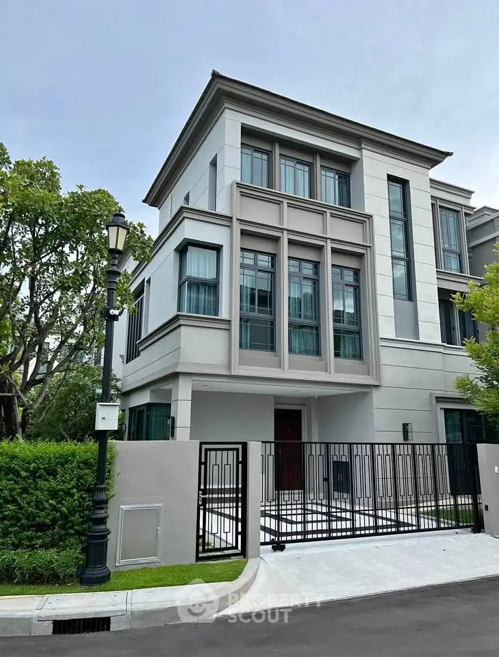 Luxurious modern townhouse with sleek design and gated entrance in a serene neighborhood.