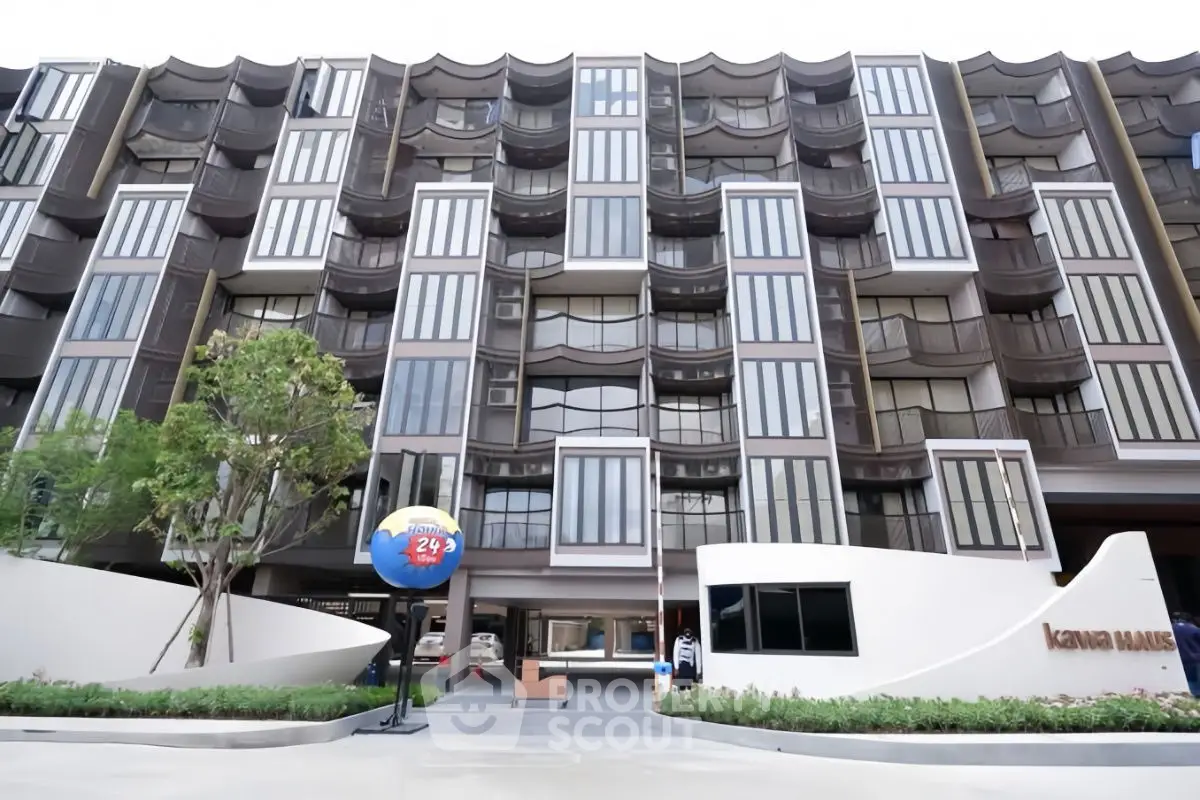 Modern apartment building exterior with unique architectural design and lush landscaping.