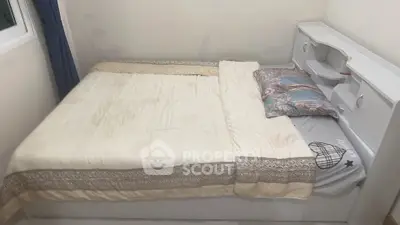 Cozy bedroom with elegant bedding and built-in storage headboard