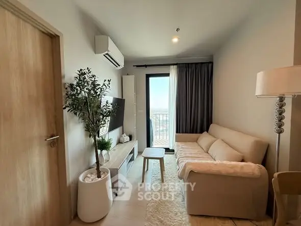 Modern living room with cozy sofa, TV, and balcony view