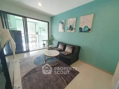 Modern living room with stylish decor and balcony access