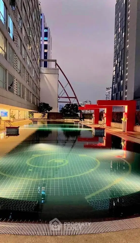 Luxurious rooftop pool with stunning cityscape views in modern high-rise building.